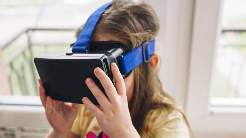 girl adjusting VR headset standing in a room