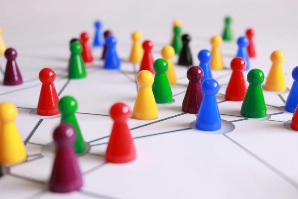 Colorful game pawns on a white board with grid lines.